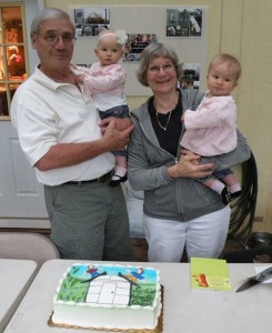 Mike and Bev Perry, founders of Solexx Greenhouses, with their granddaughters